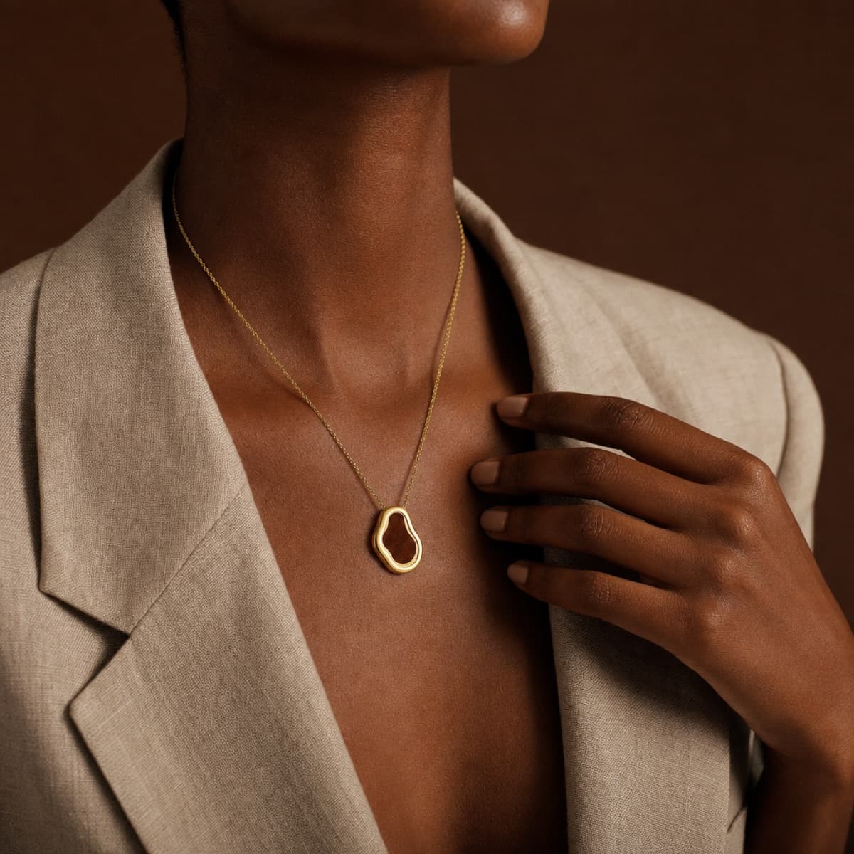 The Texas necklace in gold worn with a linen blazer